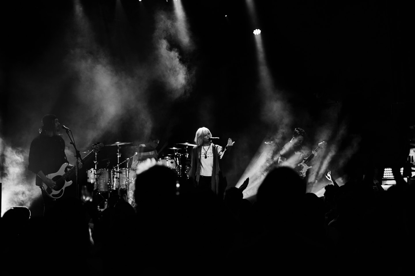 Live band performs for a cheering crowd on stage.